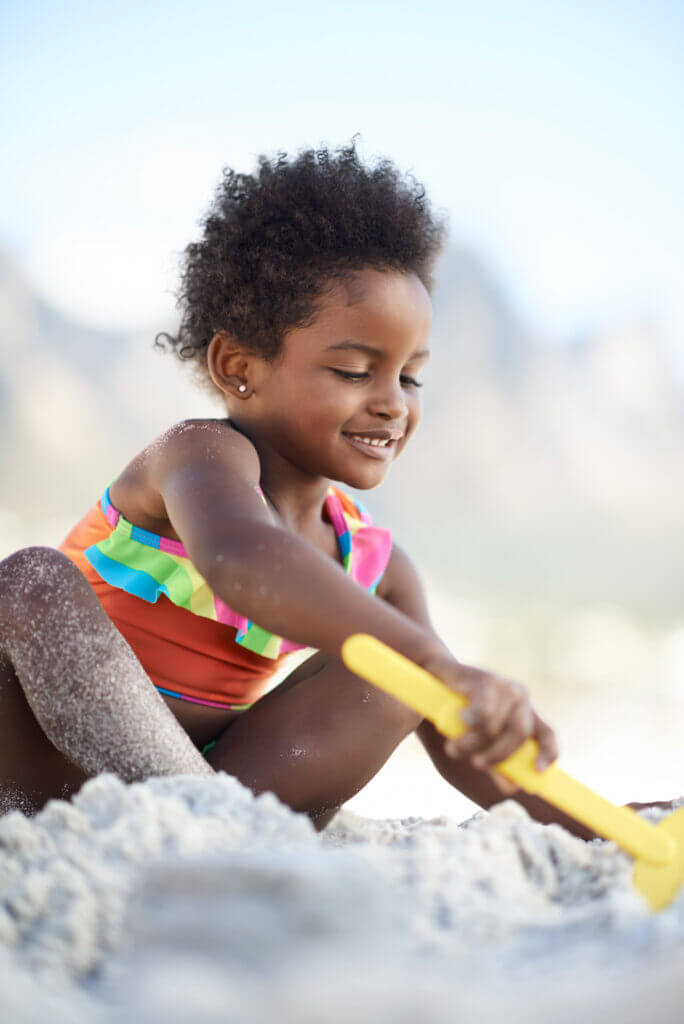 Young girl building a sandcastle