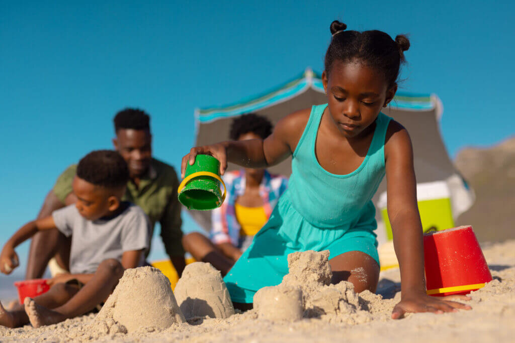 Children playing in the sand together on a sunny day